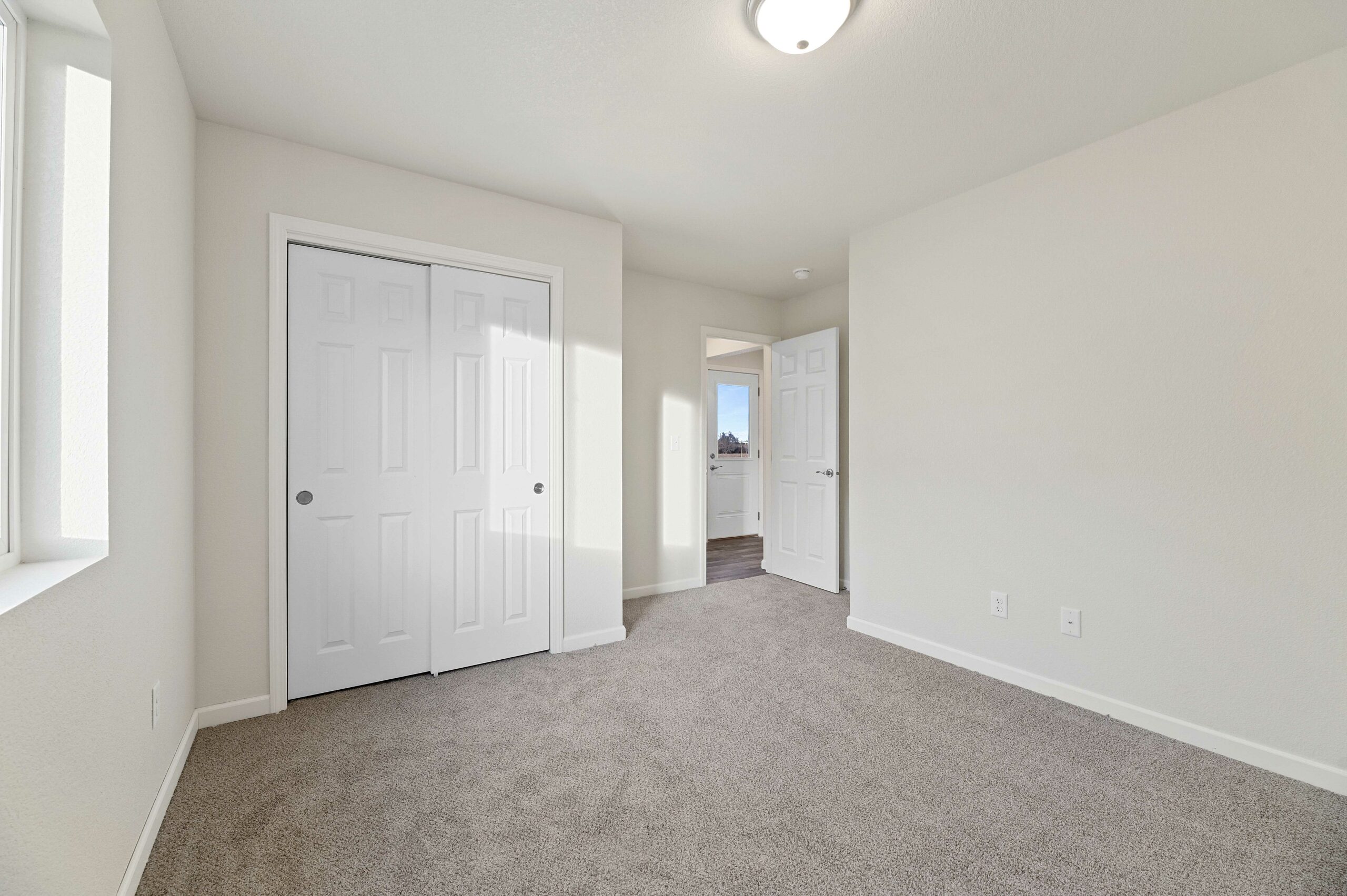 inside of an empty bedroom in a brand new home