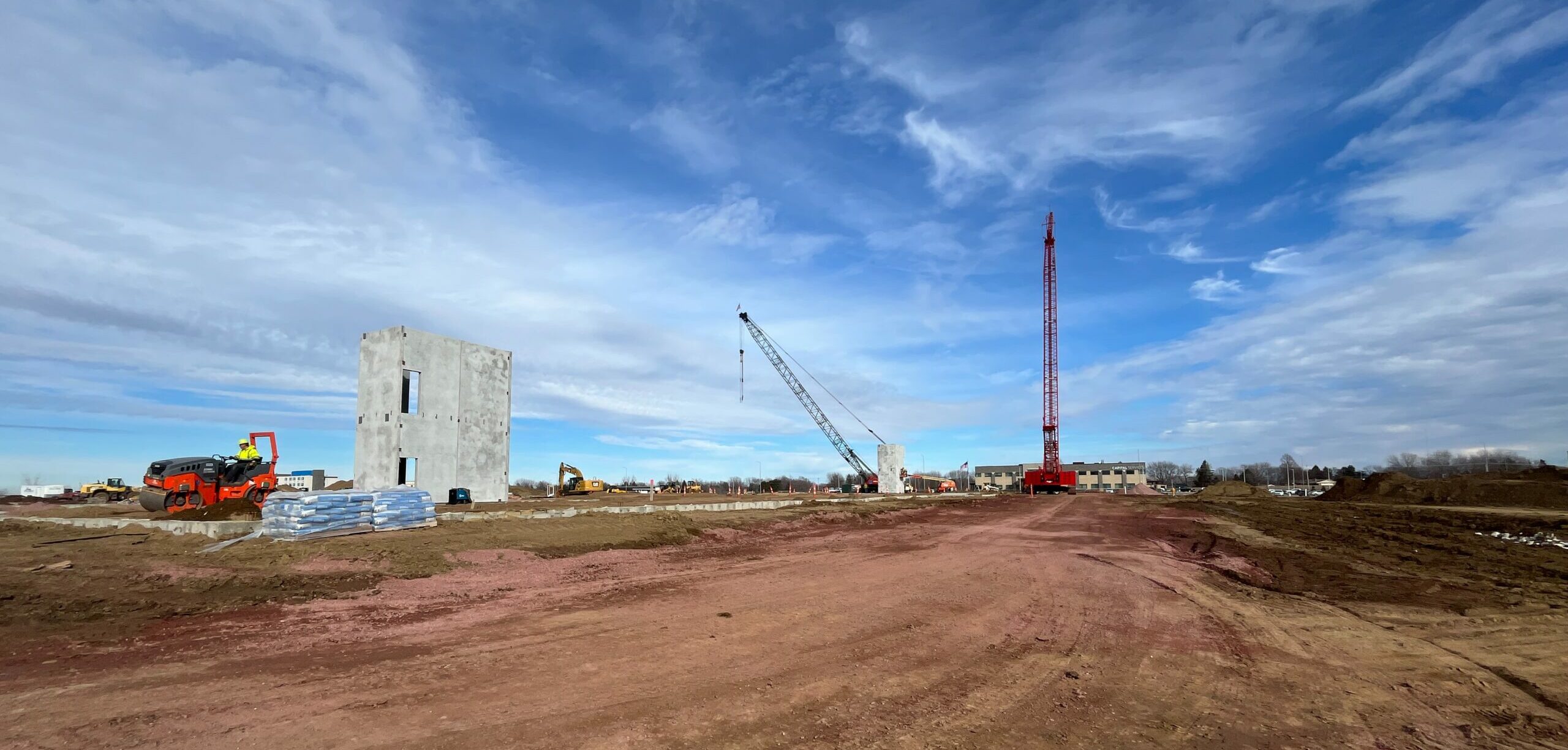 cranes and precast concrete at a construction site in Sioux Falls