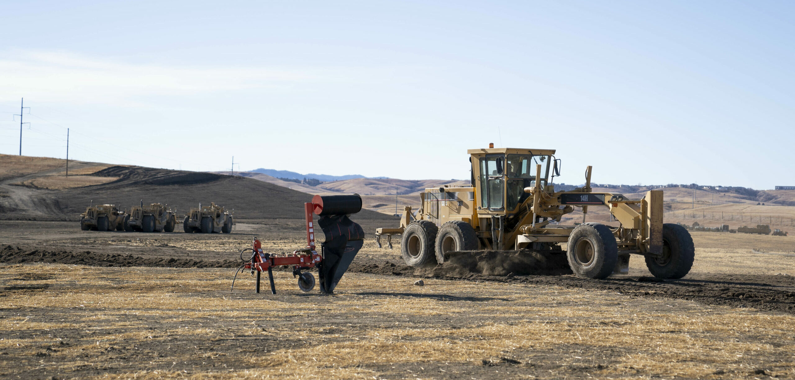 large blader scraping dirt to create a flat terrain at the Black Hills Industrial Center